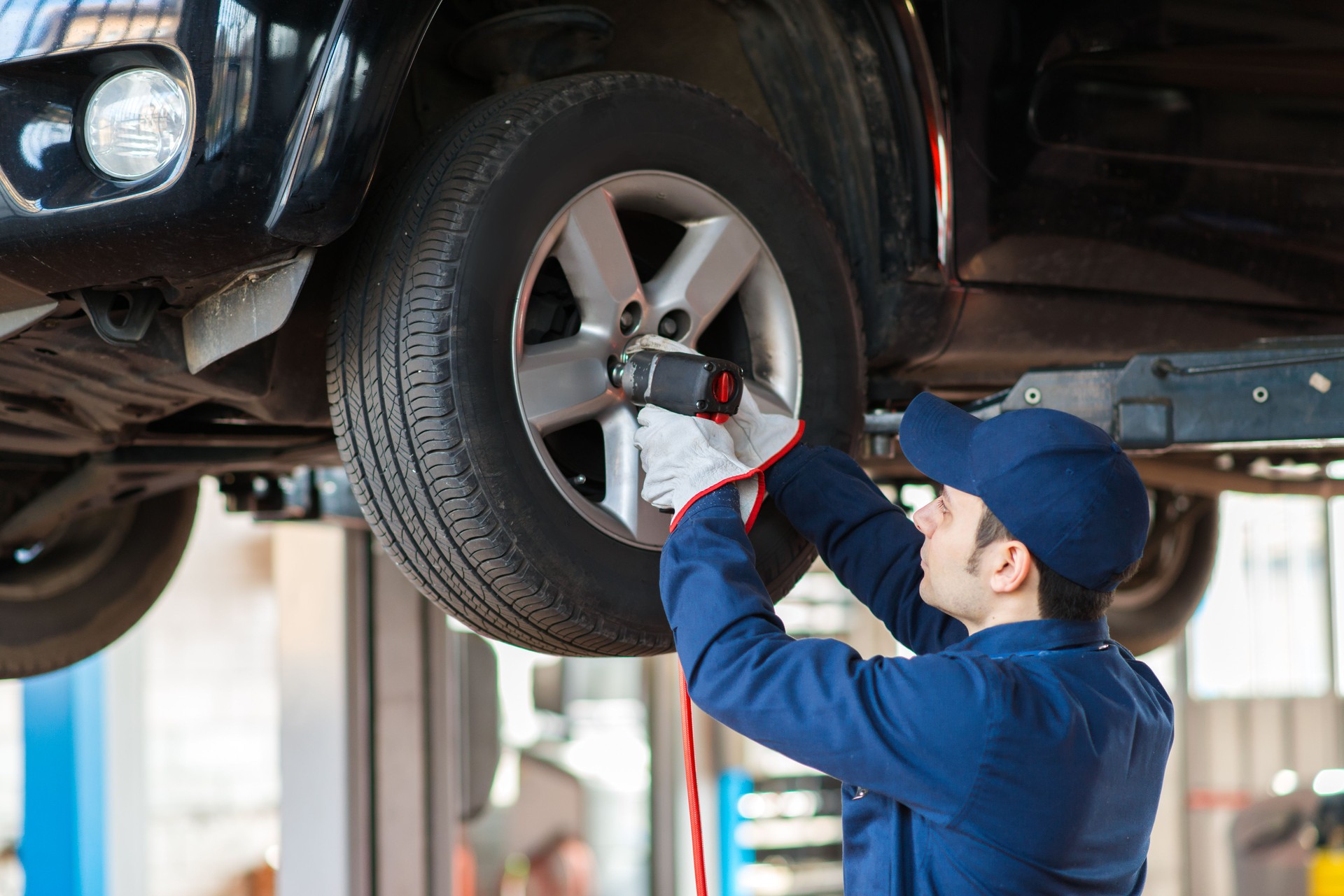Portrait of a mechanic replacing wheel